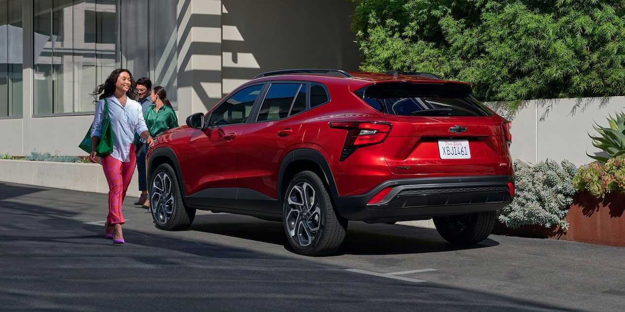  Woman walking by a 2025 Chevrolet Trax 