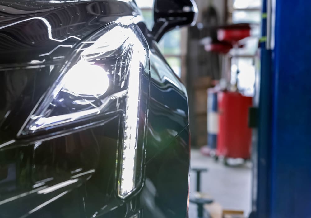 headlight and front bumper on a black car