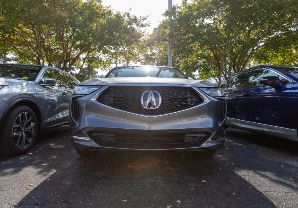 Close up shot of the front grille of a new Acura SUV parked in the lot at Flow Acura of Wilmington
