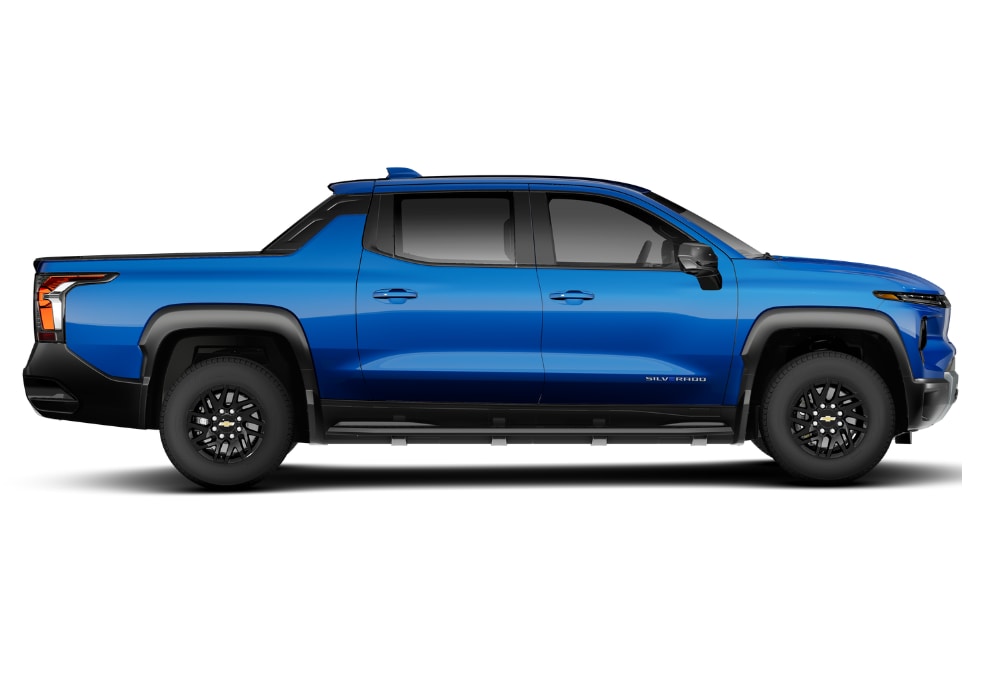 Passenger's side view of a 2025 Chevy Silverado EV. The truck is blue and it is in front of a white background