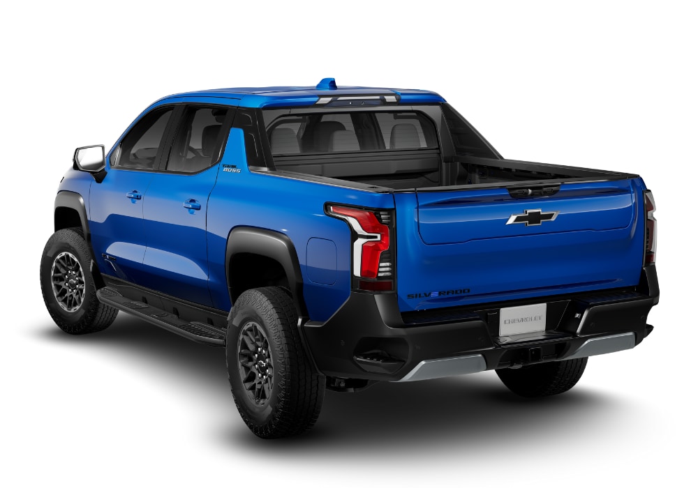 Rear 3/4 view of the 2025 Chevrolet Silverado EV pickup truck in front of a white background