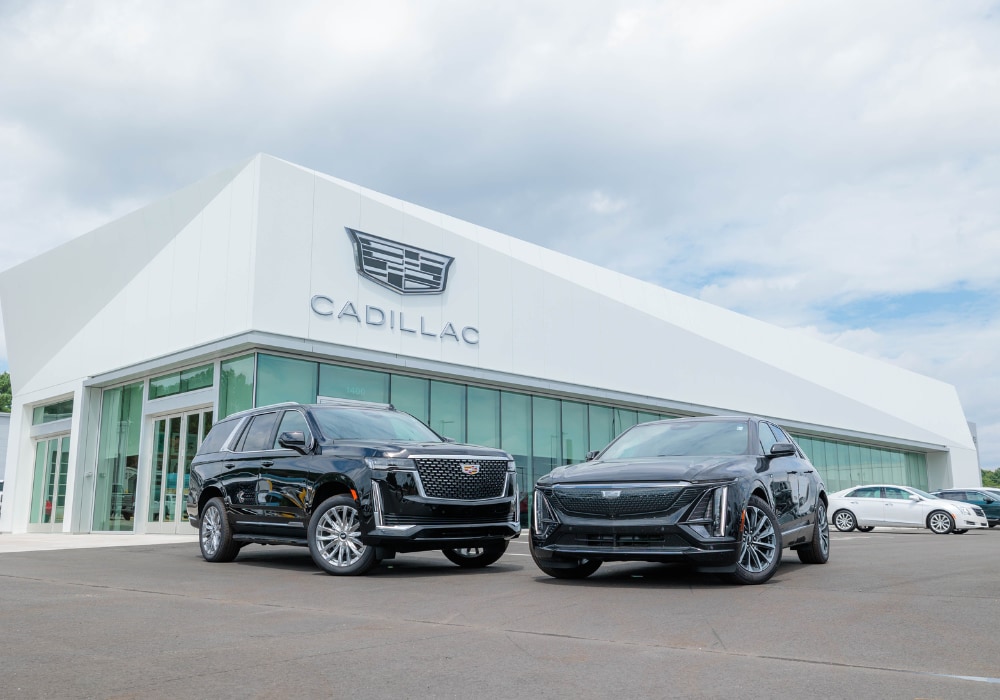 Two Cadillac SUVs parked outside the Flow Cadillac dealership in Winston-Salem, NC