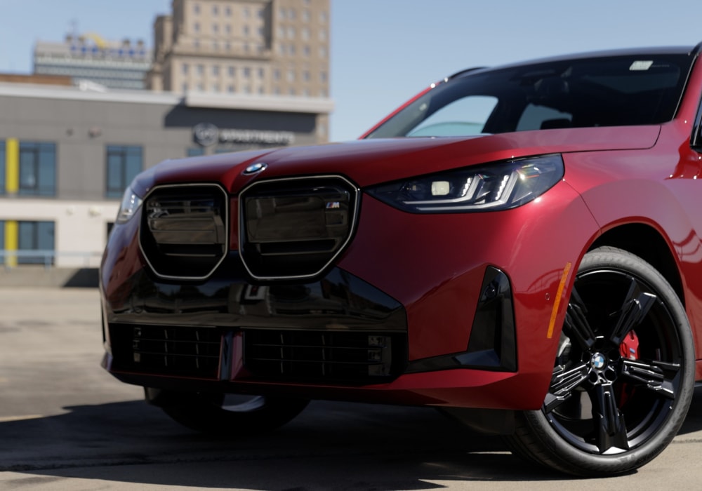 Close up of the front of a BMW X3 in the color red