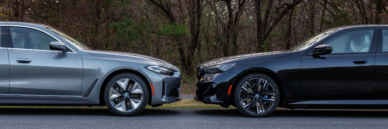 bmw-used-ev-research.png two BMW EV cars facing each other. There are trees in the background