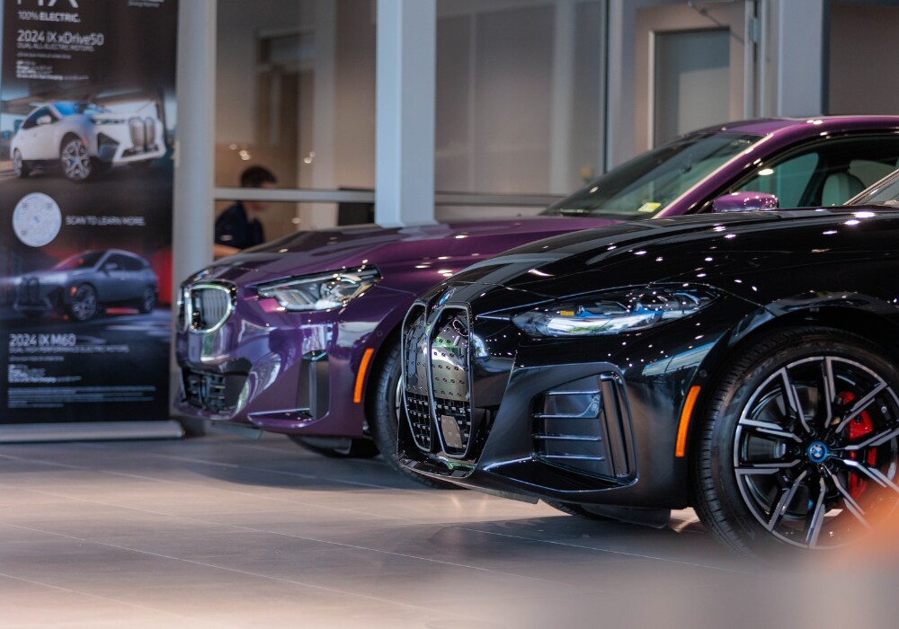 Two BMW sedans parked inside the dealership at BMW of Charlottesville