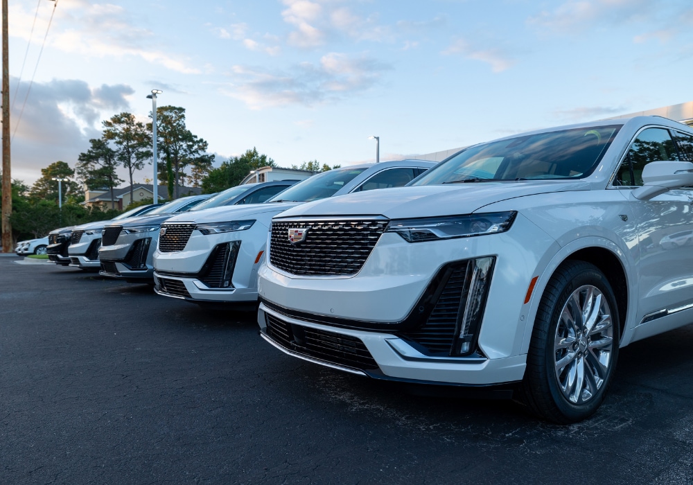 Lineup of Cadillac cars for sale in the parking lot of Flow Cadillac of Wilmington