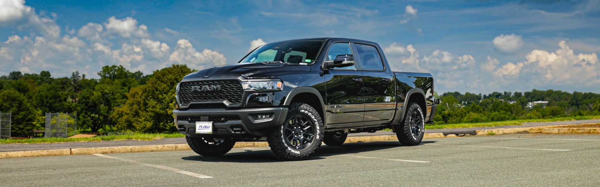 Black RAM 2500 pickup truck parked in an empty lot
