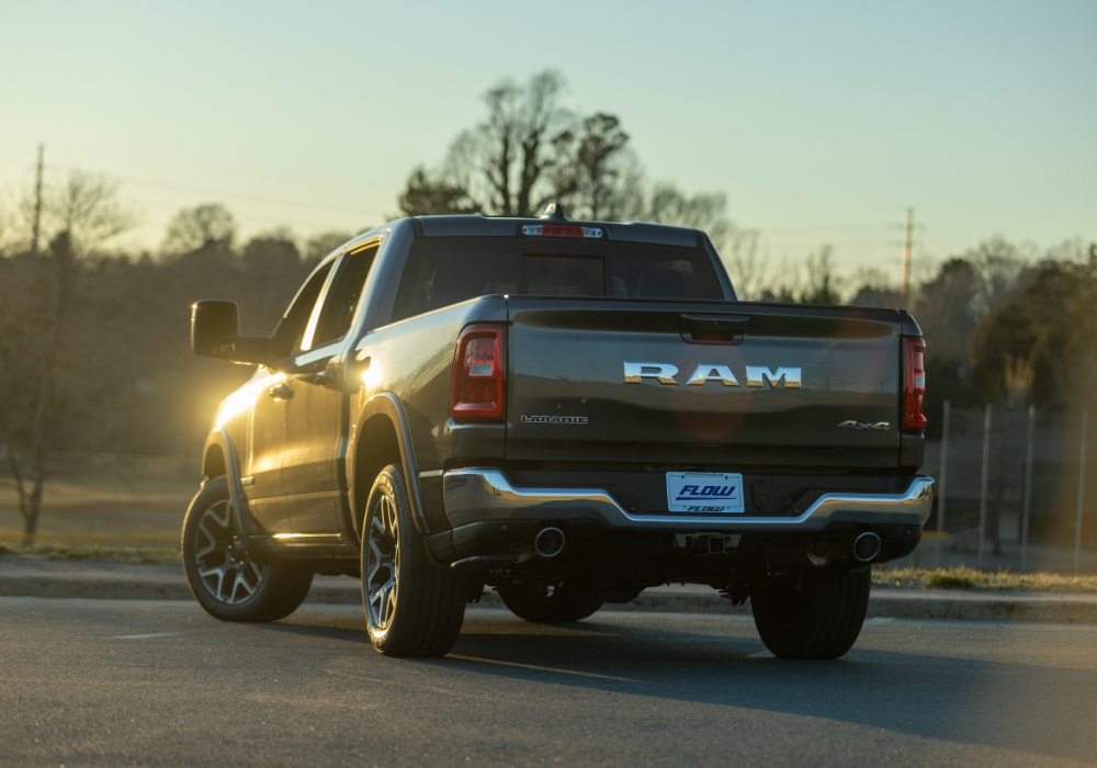 A Ram 1500 pickup truck parked with the rear of the truck facing towards the camera. The Ram logo is prominent on the back gate of the truck