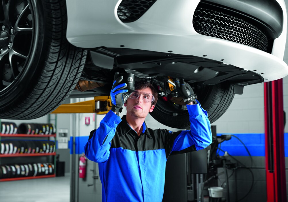 mopar service technician changing the oil in a vehicle