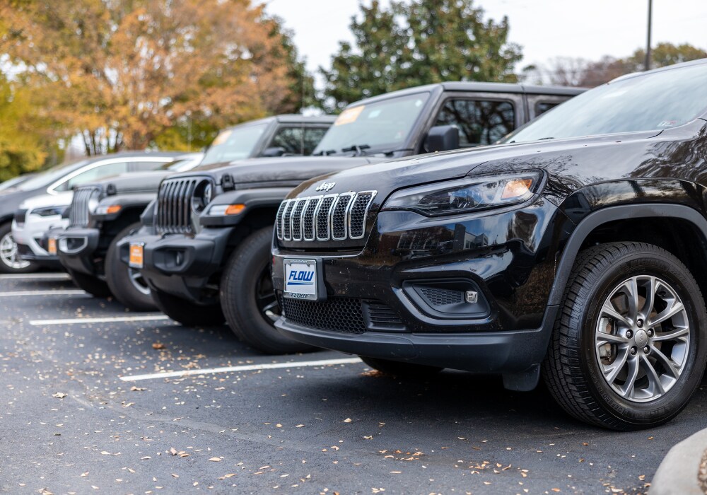 Lineup of Jeep vehicles in the lot of the Flow Chrysler Doge Jeep Ram Dealership