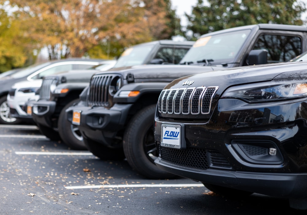 Lineup of Jeep vehicles parked in the lot of Flow Chrysler Dodge Jeep Ram of Charlottesville