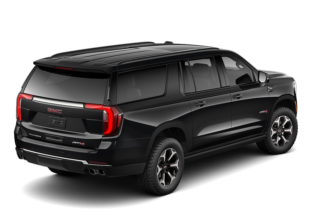 gmc-yukon-xl-specs.jpg Rear 3/4 passenger's side view of a new GMC Yukon XL in front of a white background