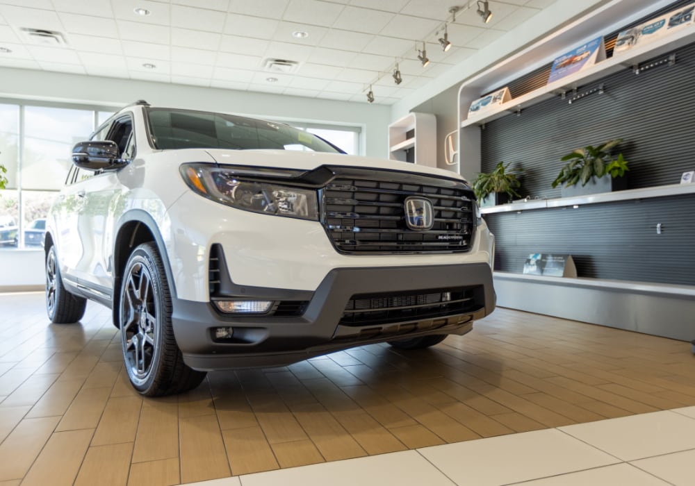 White Honda SUV parked inside the showroom at Flow Honda in Winston-Salem