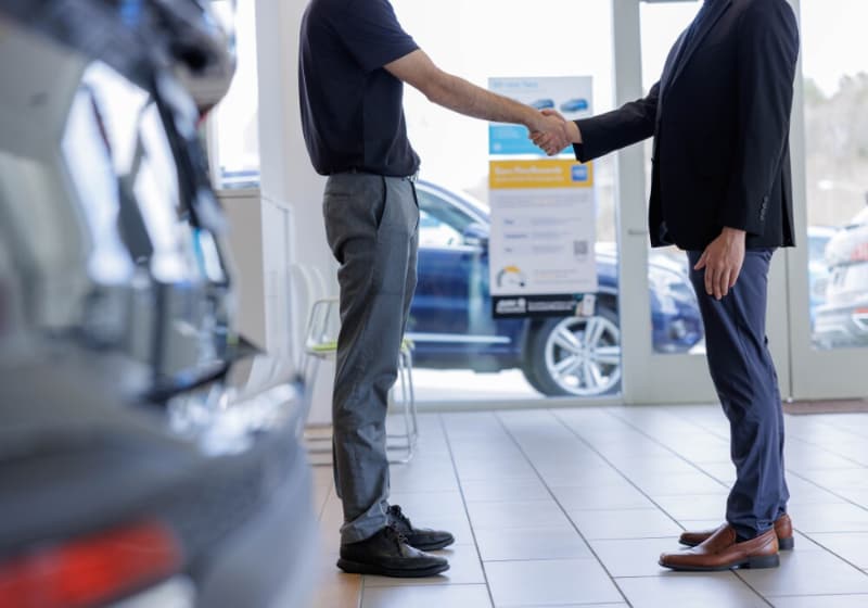 honda-lease-offers-winston-salem.jpg An employee shaking hands with a customer inside the Flow Honda Winston-Salem dealership