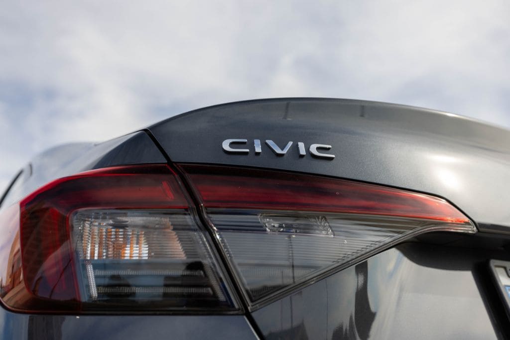 Closeup back view of a Honda Civic for sale, zoomed in on the Civic emblem