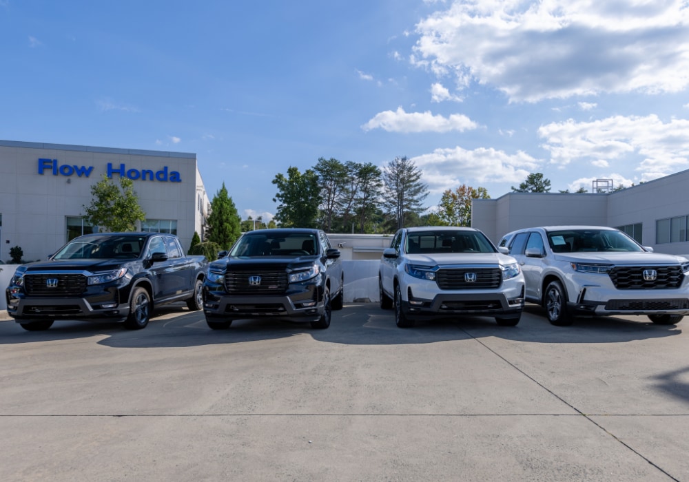 Lineup of used Honda cars for sale parked in front of the Flow Honda in Winston-Salem dealership