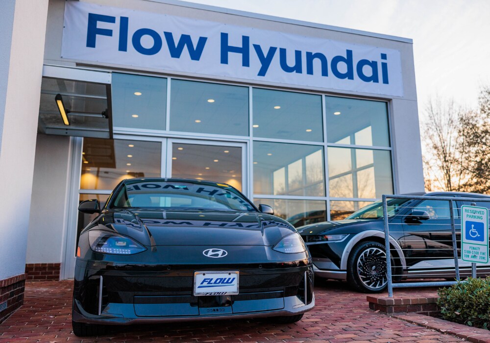 Black Hyundai sedan parked directly in front of the Flow Hyundai of Charlottesville dealership