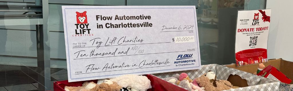 Ceremonial check of $10,000 donation from Flow Automotive in Charlottesville to Toy Lift Charities 