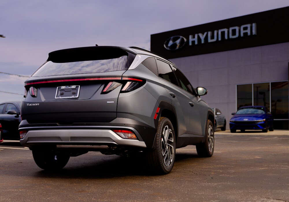 Hyundai Tucson parked outside of a Hyundai dealership