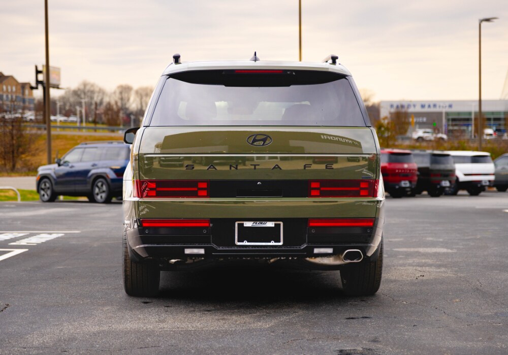 Rear exterior view of a 2026 Hyundai Santa Fe parked in a dealership lot with several other cars