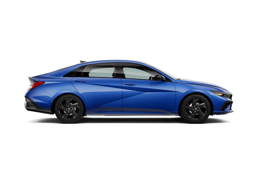 hyundao-elantra-for-sale.png Passenger side view of a 2025 Hyundai Elantra in front of a white background