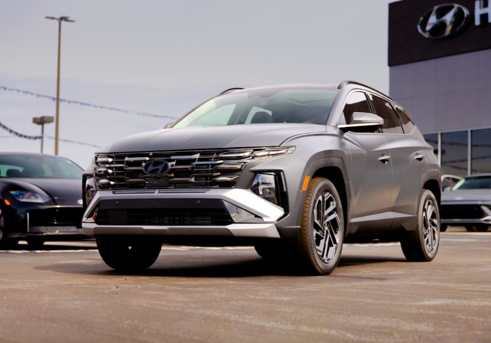 2026 Hyundai Tucson parked in front of the Flow Hyundai of Statesville. The SUV is gray