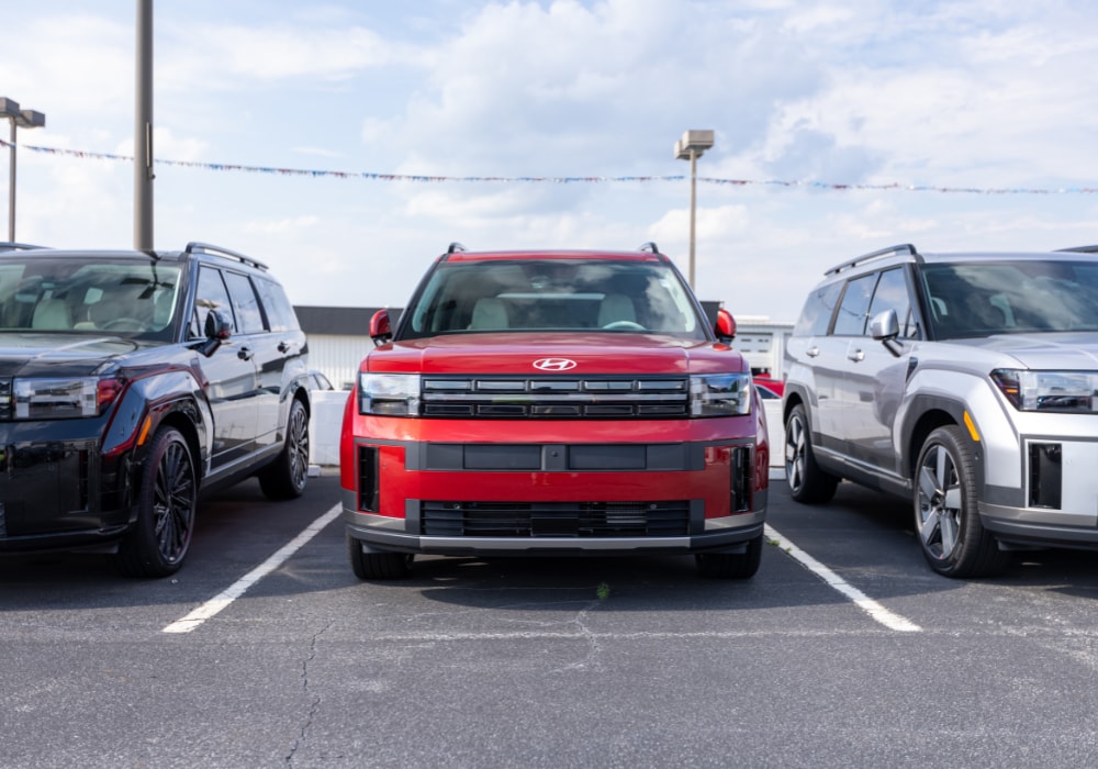 Lineup of three Hyundai SUVs parked in the lot of the Flow Hyundai of Statesville dealership