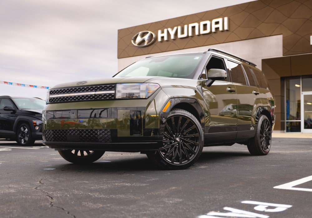 Green 2026 Hyundai Santa Fe for sale parked in a Hyundai dealership lot
