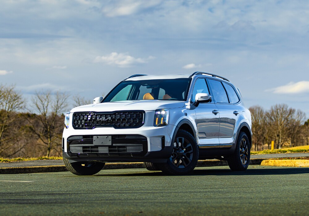 2025 Kia Telluride SUV parked on a paved lot. The car is white.