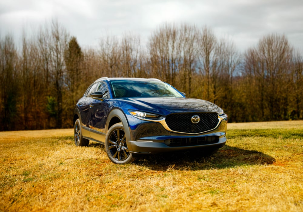 2025 Mazda CX-30 parked in a grassy field with trees in the background