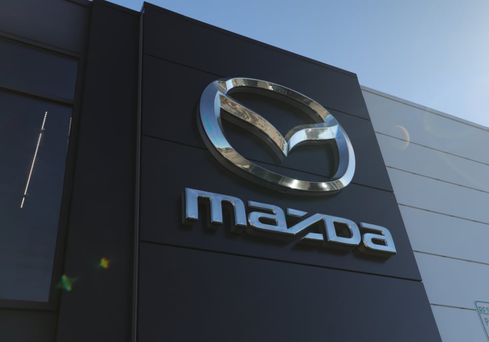 Mazda logo on the front of the Flow Mazda of Fayetteville dealership