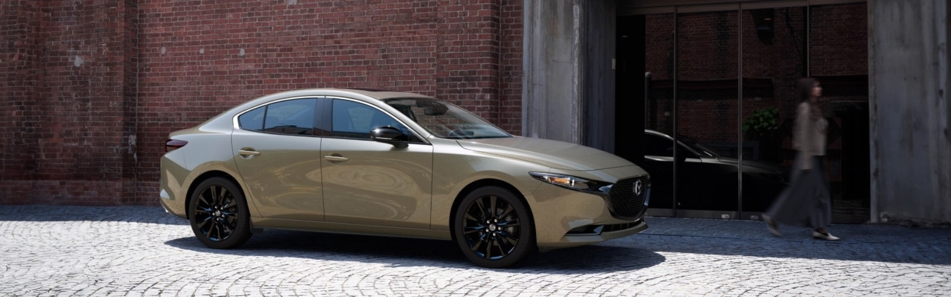 2025 Mazda3 sedan parked in front of a brick building