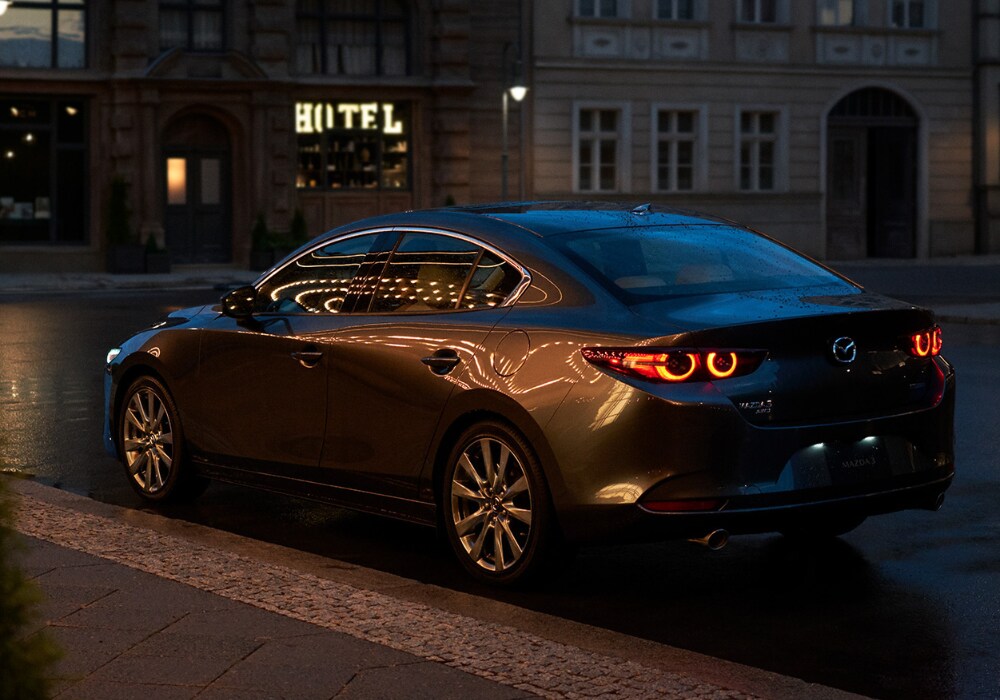 new-mazda3-performance.png New Mazda3 sedan parked on a city street
