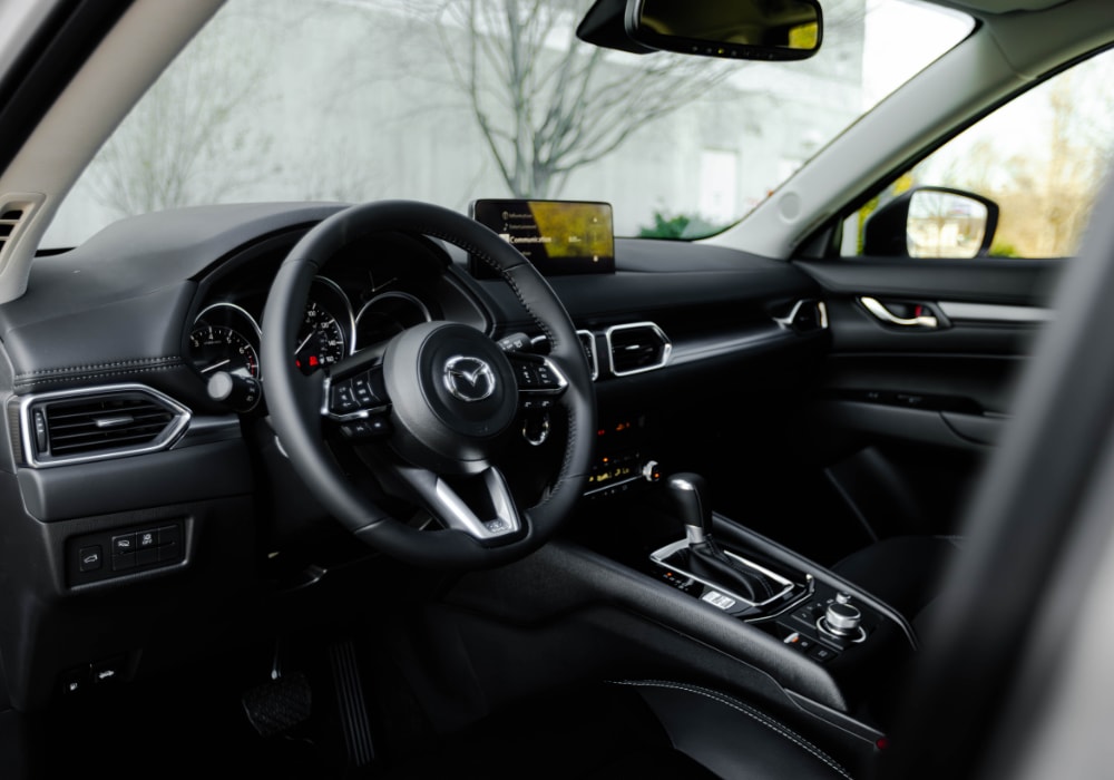 the interior of a 2025 Mazda CX-5 for sale in Greensboro. The interior of the car is black