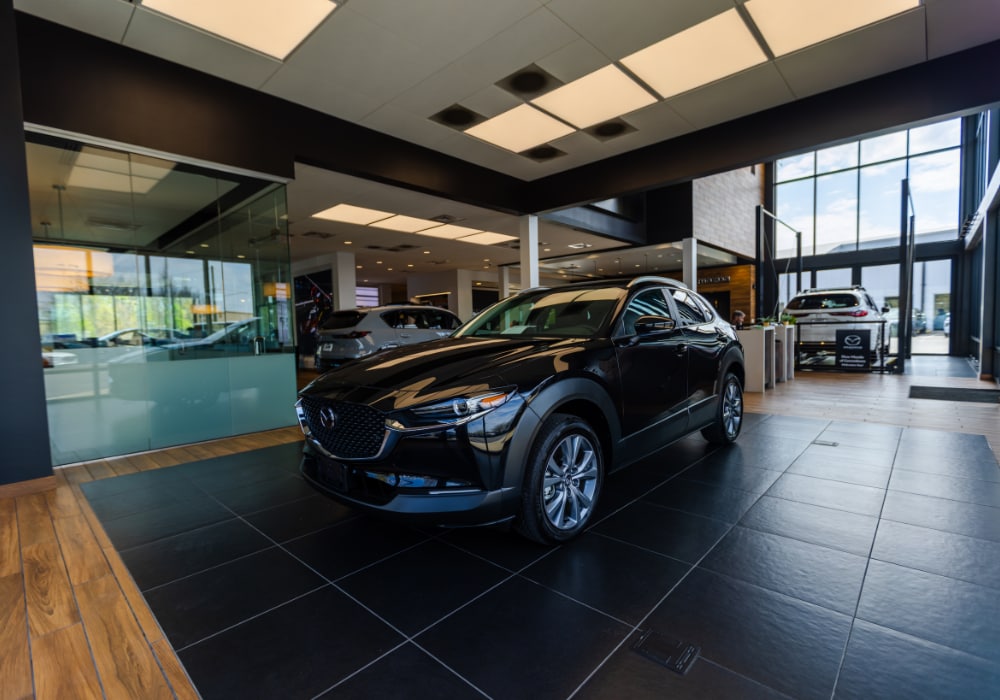 Mazda SUV parked inside the Flow Mazda of Greensboro showroom