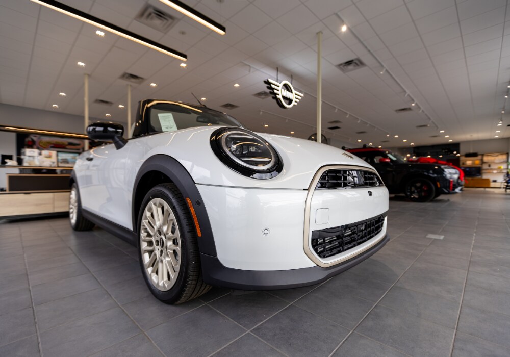 White Mini Cooper parked inside the Flow MINI of Raleigh showroom