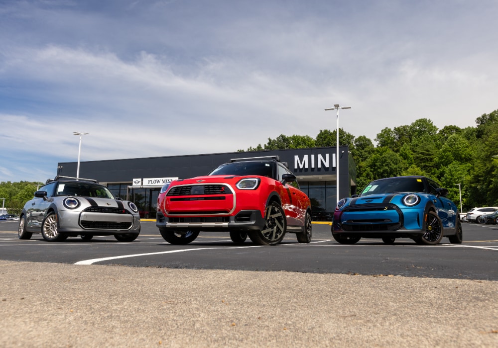 Three Mini cars parked in front of the Flow MINI dealership in Winston-Salem