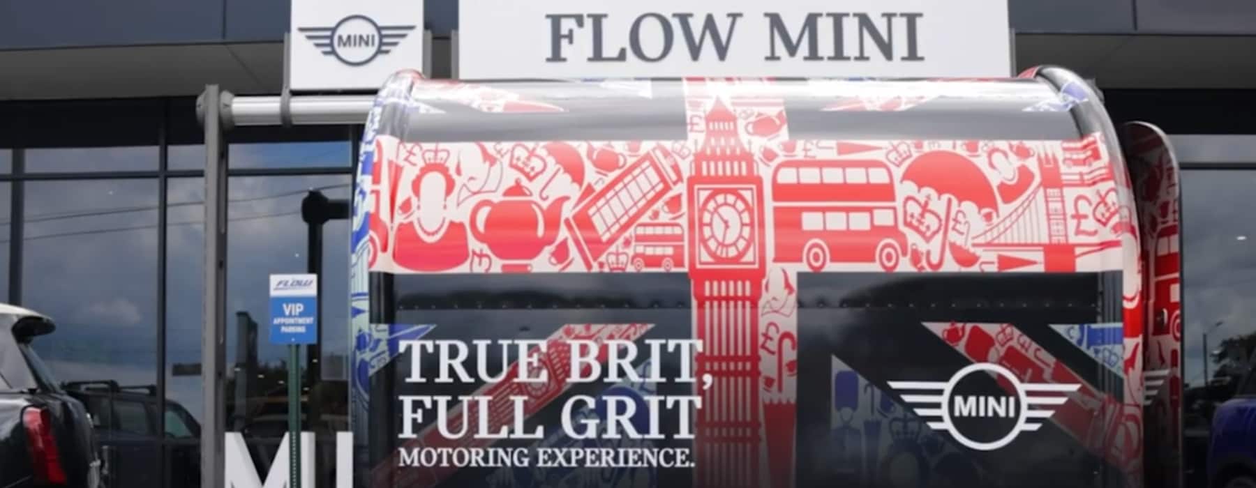 True brit full grit trailer parked in front of the Flow Mini dealership