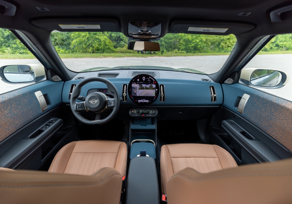 Mini Cooper Countryman interior, including the infotainment system. The seats are light brown leather