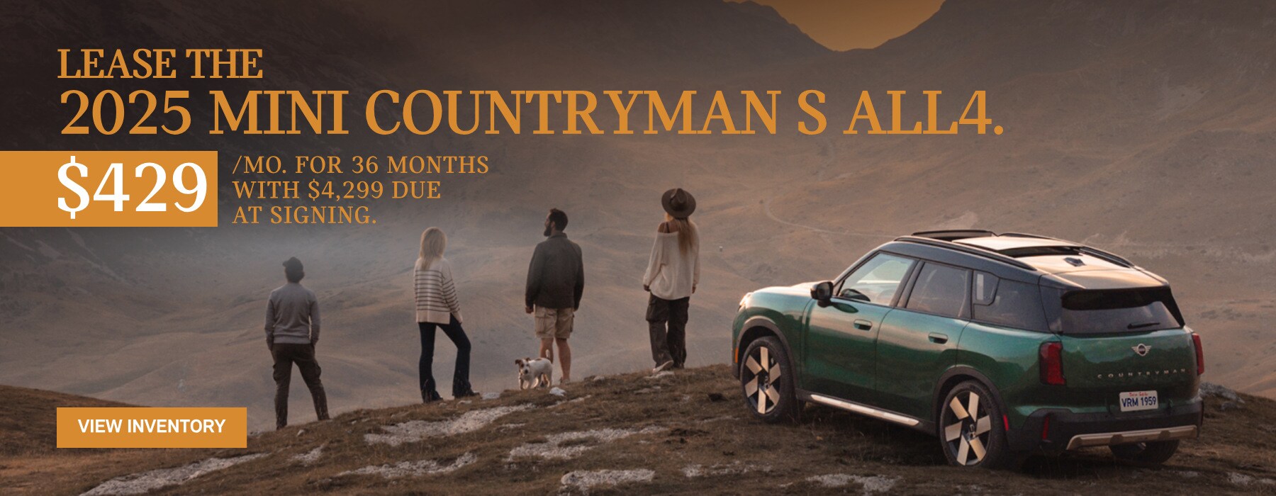 MINI Countryman parked with a family of 4 and their dog on a snow hill across a valley in the mountains.
