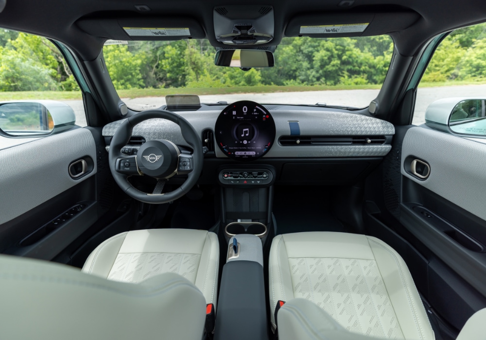 Mini Cooper 4 Door interior, featuring the infotainment system and white uphosterly