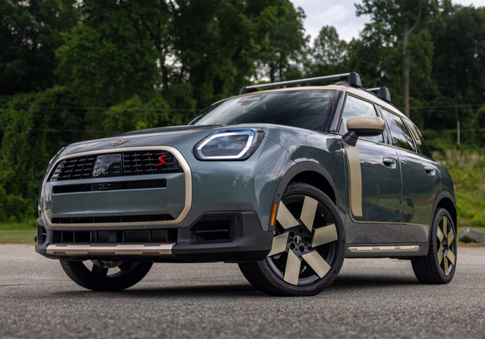 Front view of a 2026 Mini Cooper Countryman. The car is gray with gold accents