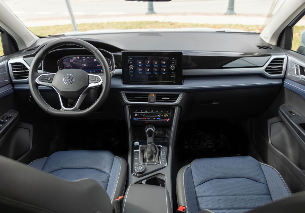 2025 Volkswagen Taos interior including the infotainment system and steering wheel