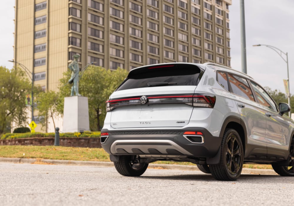 Rear exterior photo that shows the new Volkswagen Taos parked in front of a tall building