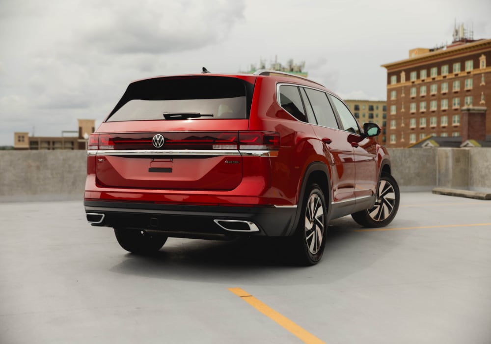 Rear view of a Volkswagen Atlas. There are buildings in the background