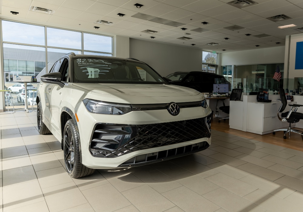 White Volkswagen SUV parked inside the showroom at Flow Volkswagen of Winston-Salem