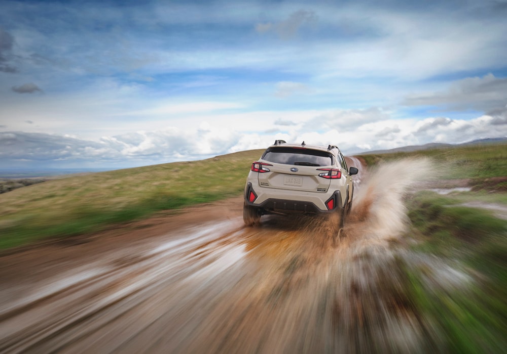 Subaru Crosstrek Hybrid driving down a dirt path