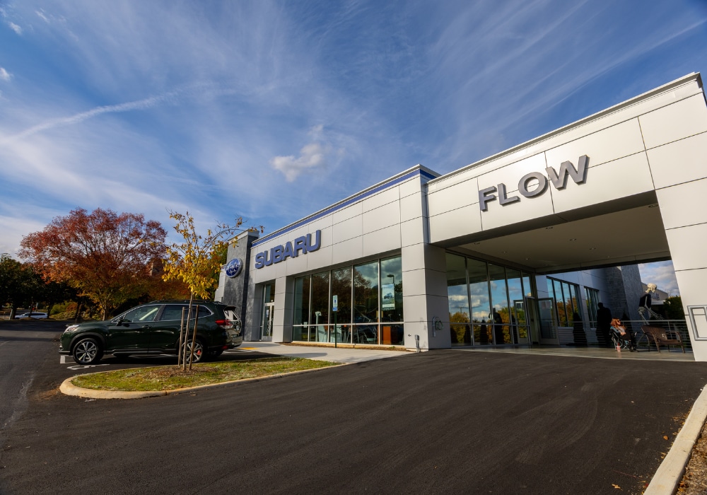 Flow Subaru of Charlottesville dealership with a car parked out front