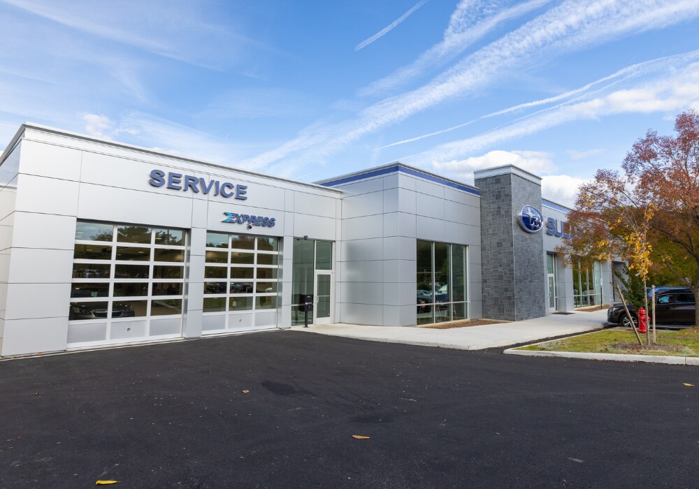 Flow Subaru of Charlottesville dealership, showing the service department with a blue sky in the background