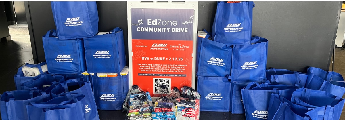 A large stack of donations in Flow Auto branded bags to be donated to the EdZone community drive